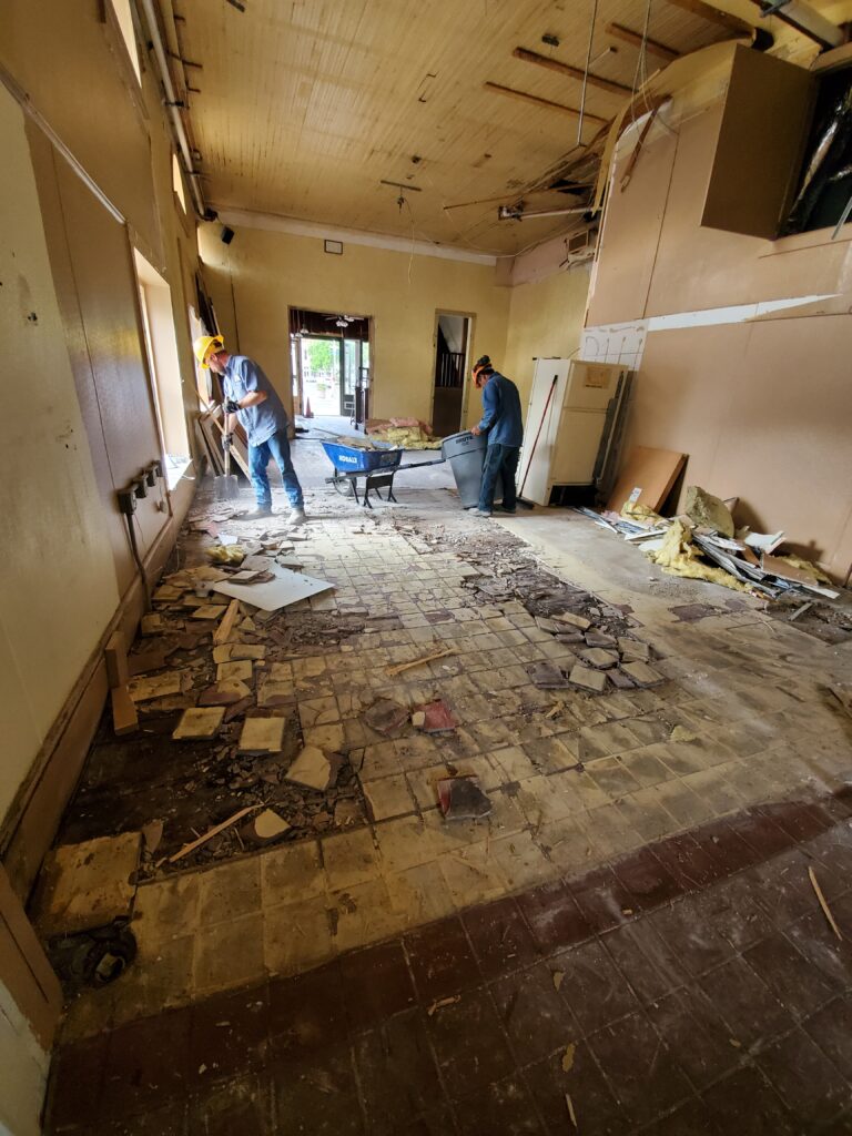 A demolition team stripping the interior of a commercial retail building to prepare it for renovation.