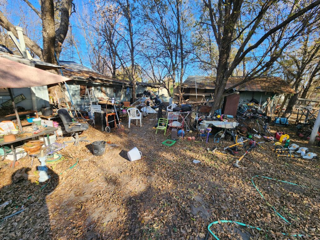 Severe hoarding clean up in Glen Rose before pictures of clutter in the yard prior to a professional demolition company cleaning it up.