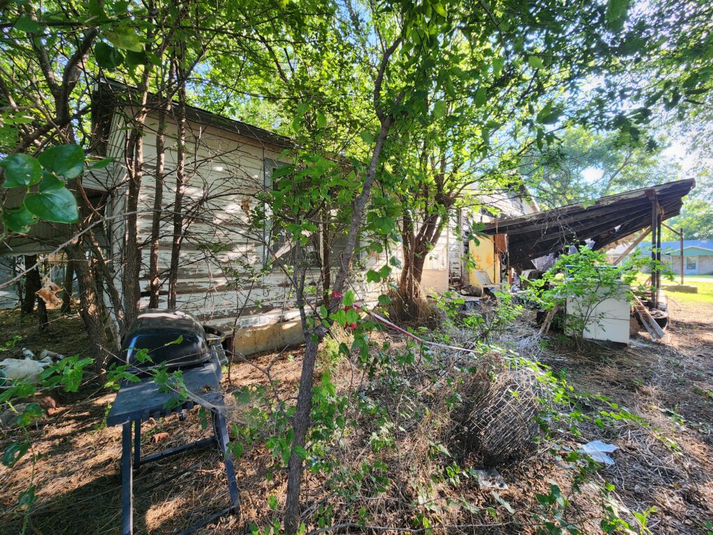 Dilapidated home that has been burned on the inside from a house fire prior to demolition