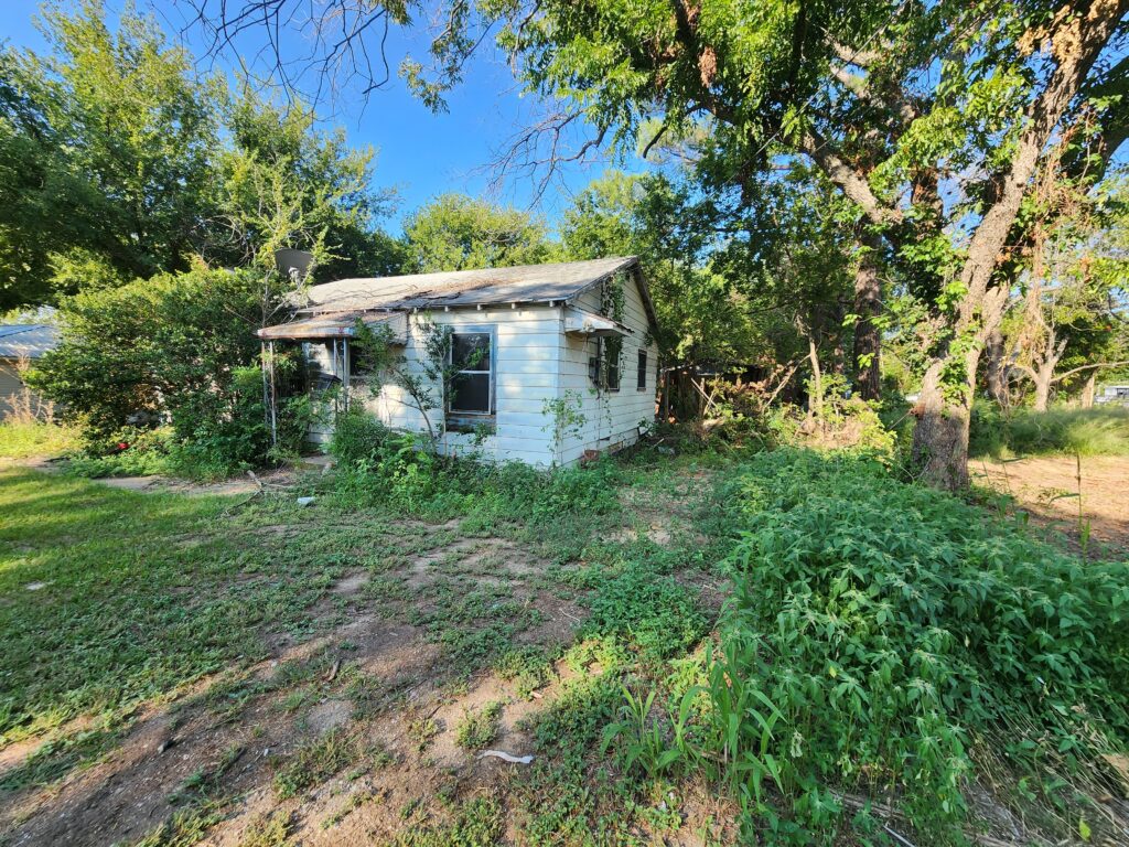 Dilapidated home that has been burned on the inside from a house fire prior to demolition