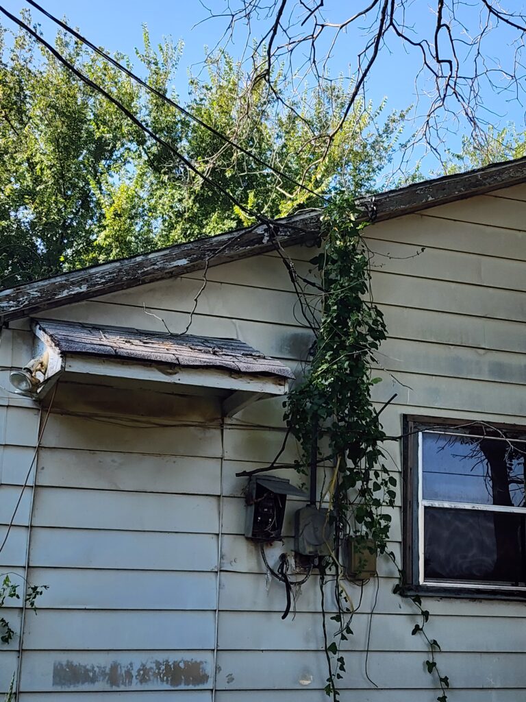 Showing smoke damage on the outside of a house prior to demolition in Tolar, TX