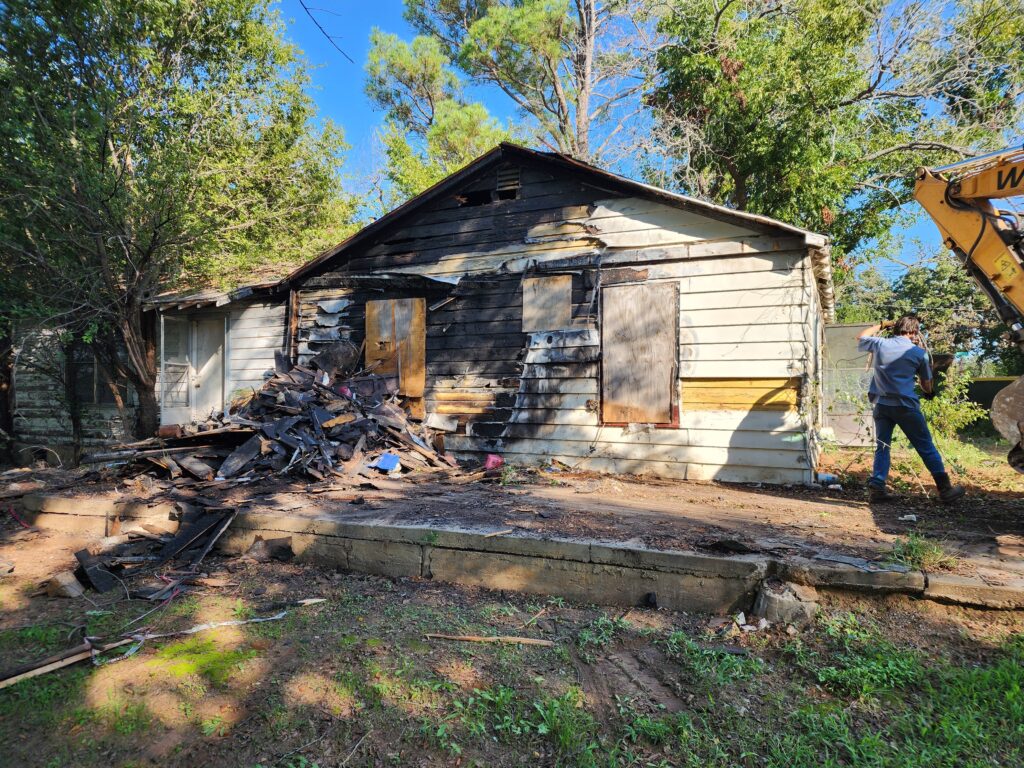 The Wannco Services team starting to prepare a dilapidated burned out home in Tolar for demolition