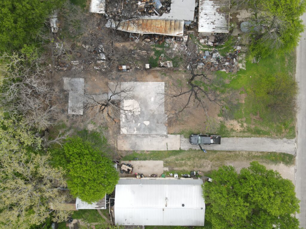 Empty property with clean concrete pad following professional demolition service in the Ports O’ Call neighborhood